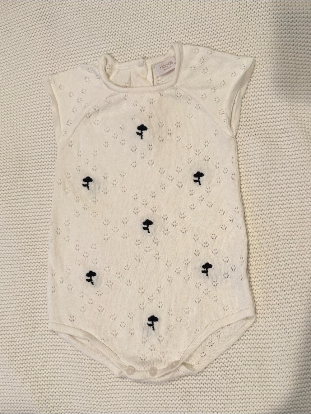 White Knit Baby One-Piece with Navy Motifs